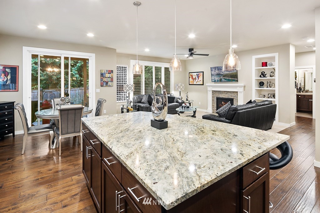 21920 37th Avenue Southeast Bothell, WA 98021 - Photo 14 of 39 a kitchen with granite countertop kitchen island stainless steel appliances a stove a table and chairs