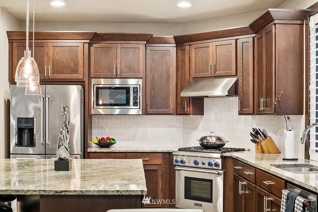 21920 37th Avenue Southeast Bothell, WA 98021 - Photo 16 of 39 a kitchen with granite countertop a stove and a sink