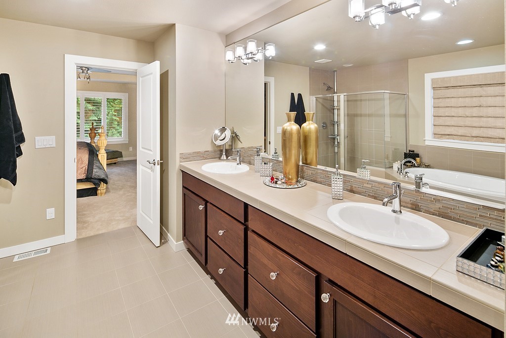 21920 37th Avenue Southeast Bothell, WA 98021 - Photo 27 of 39 a en suite bathroom with double sink and a mirror