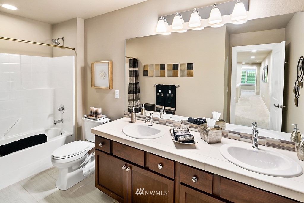 21920 37th Avenue Southeast Bothell, WA 98021 - Photo 30 of 39 a bathroom with a double vanity sink mirror and toilet