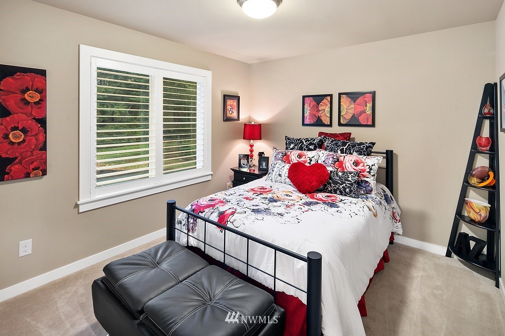 21920 37th Avenue Southeast Bothell, WA 98021 - Photo 32 of 39 a bedroom with a bed and a chandelier