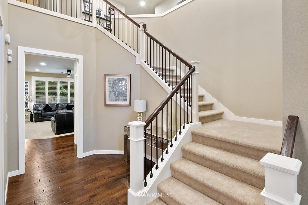 21920 37th Avenue Southeast Bothell, WA 98021 - Photo 6 of 39 a view of staircase with lots of frames on wall and couches