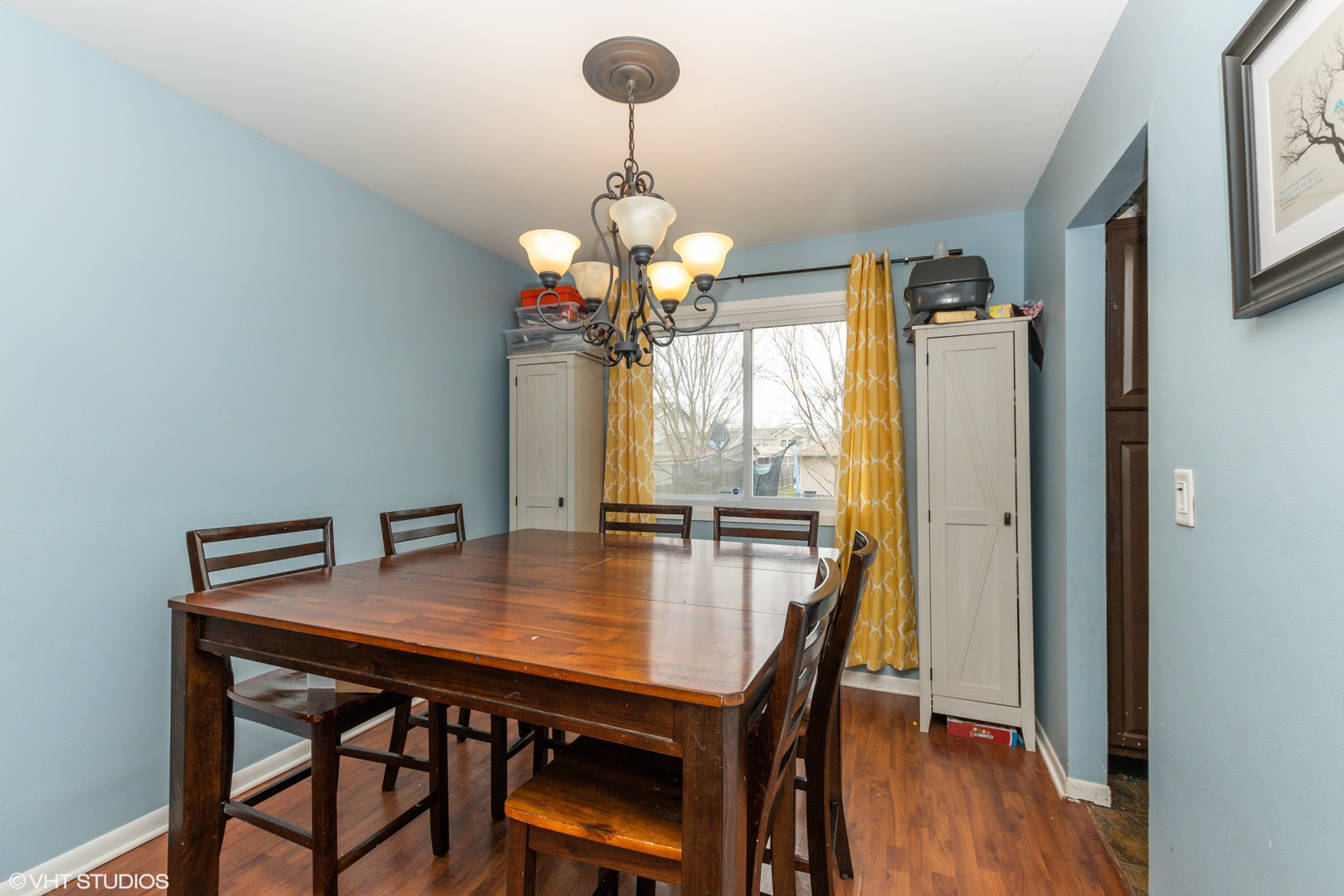 5746 Timberlane Road Matteson, IL 60443 - Photo 4 of 19 a dining room with wooden floor a chandelier a wooden table and chairs