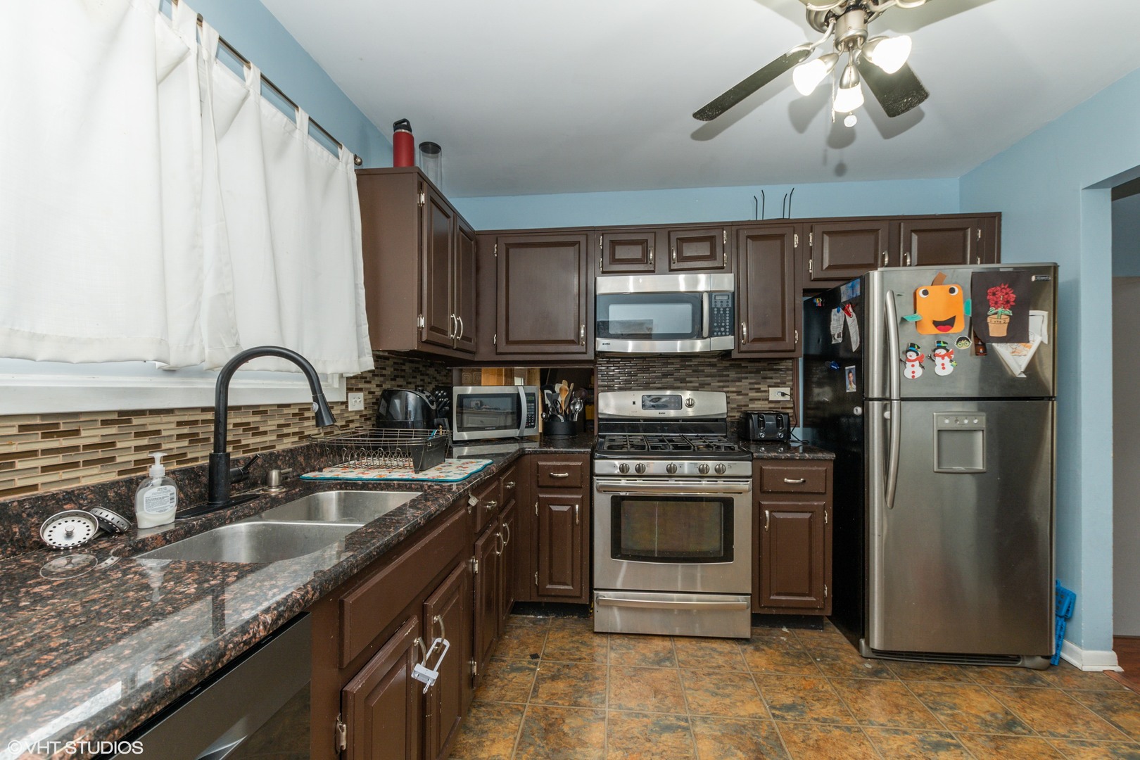 5746 Timberlane Road Matteson, IL 60443 - Photo 5 of 19 a kitchen with stainless steel appliances granite countertop a sink stove and refrigerator