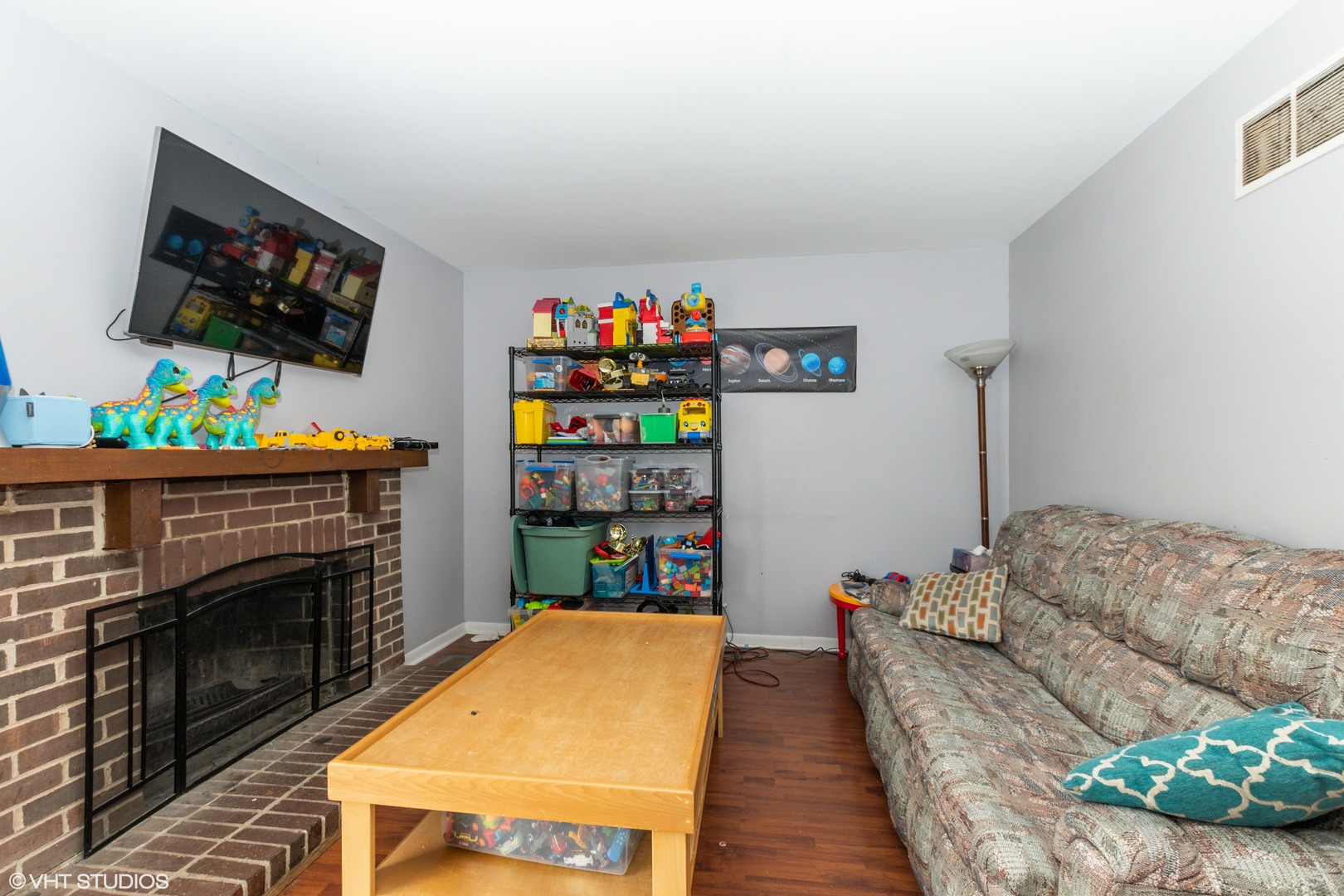 5746 Timberlane Road Matteson, IL 60443 - Photo 7 of 19 a living room with furniture a flat screen tv and a fireplace