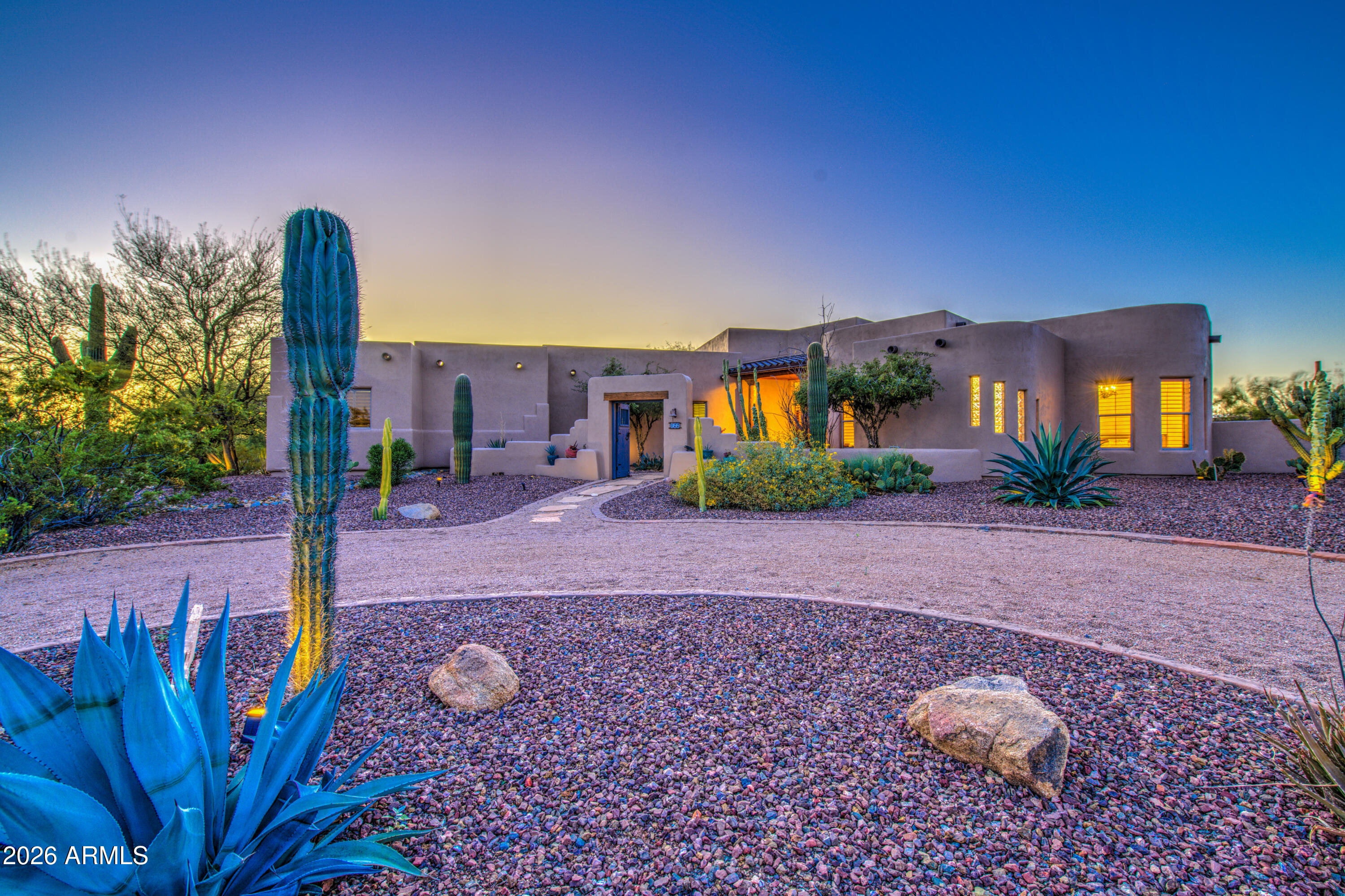 a front view of a house with garden space and street view