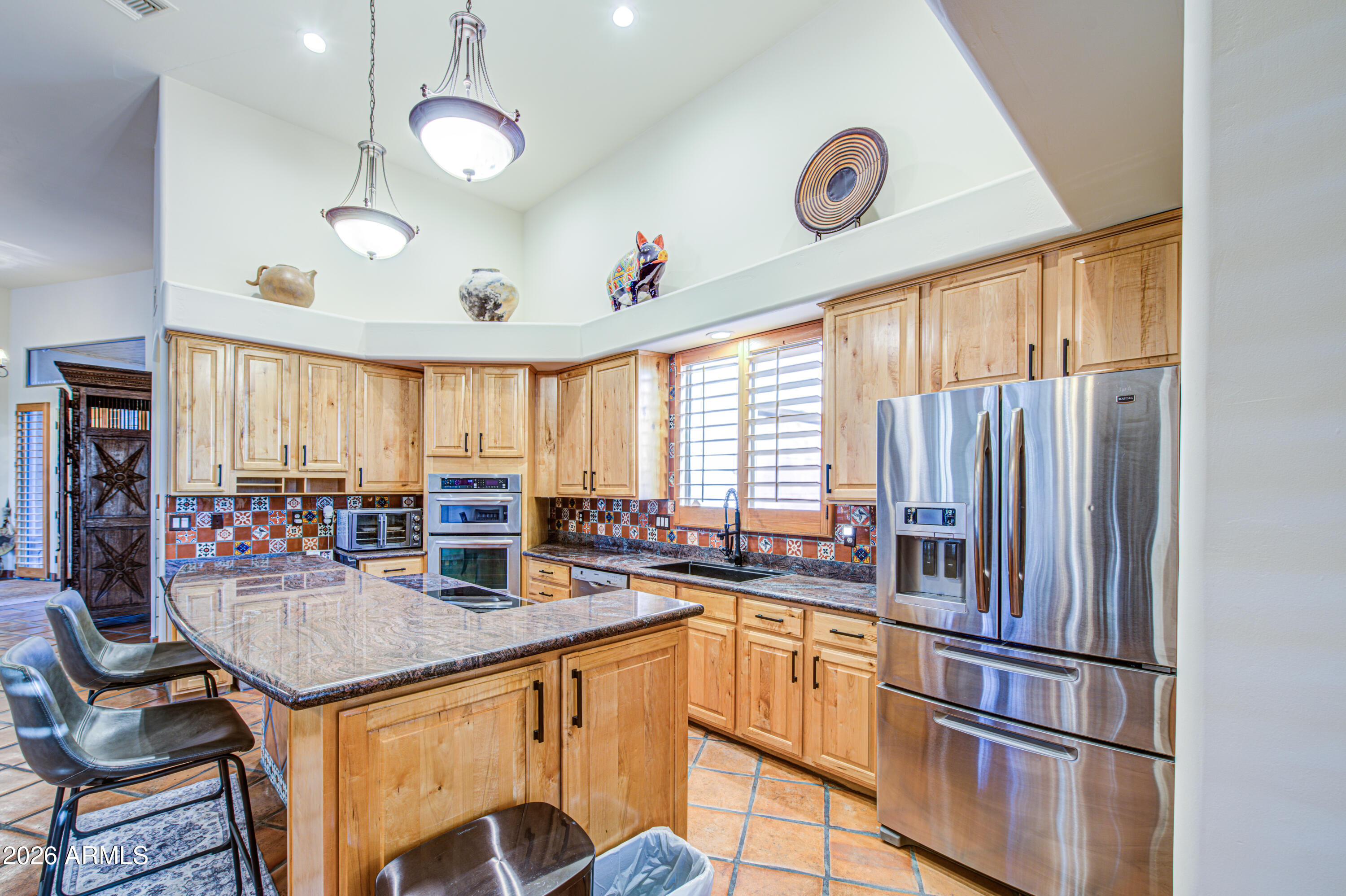 8540 East McDowell Road, Unit 122 Mesa, AZ 85207 - Photo 14 of 75 a kitchen with stainless steel appliances granite countertop a sink a stove and a refrigerator
