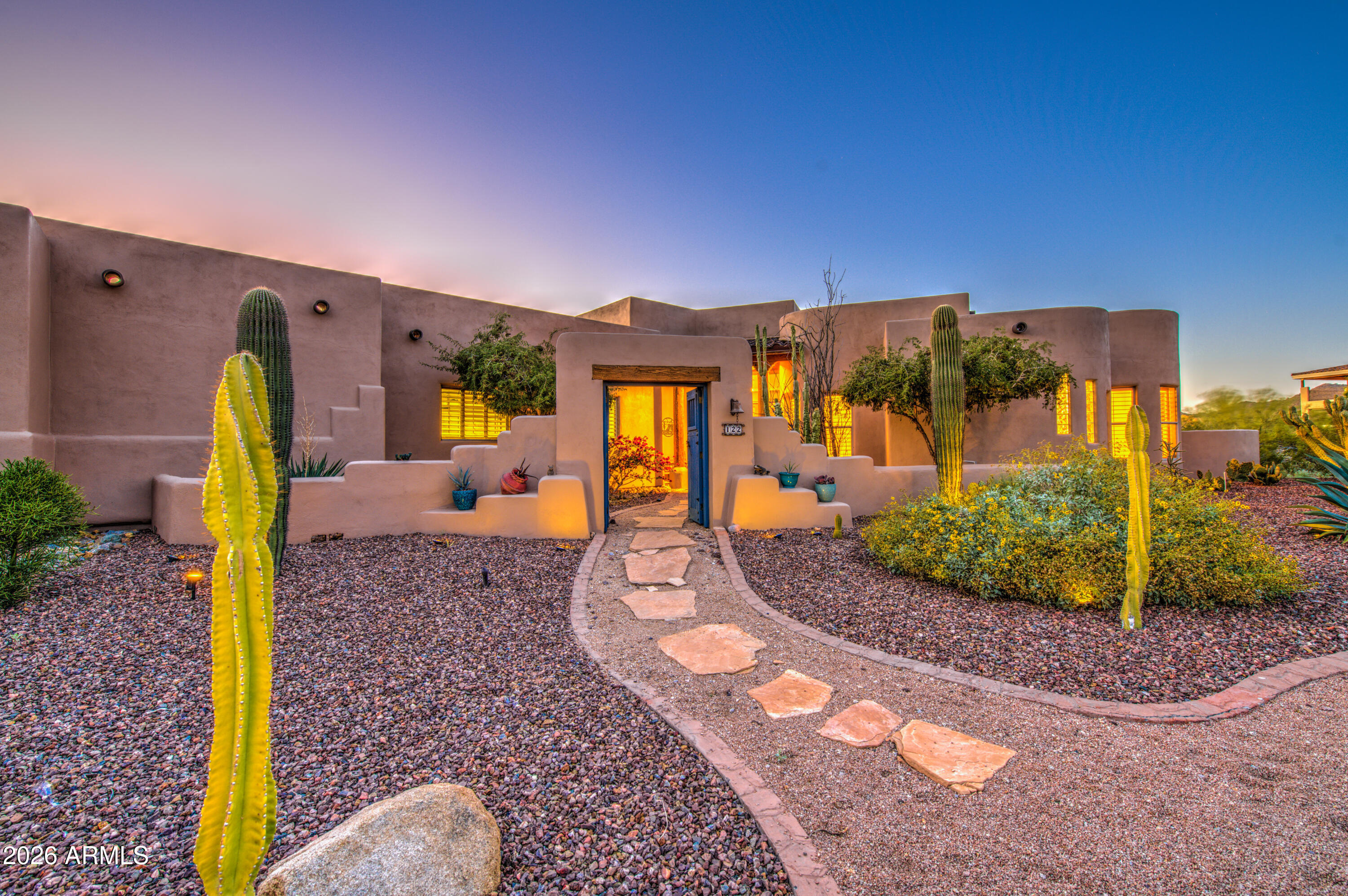 8540 East McDowell Road, Unit 122 Mesa, AZ 85207 - Photo 2 of 75 a front view of a house with a yard