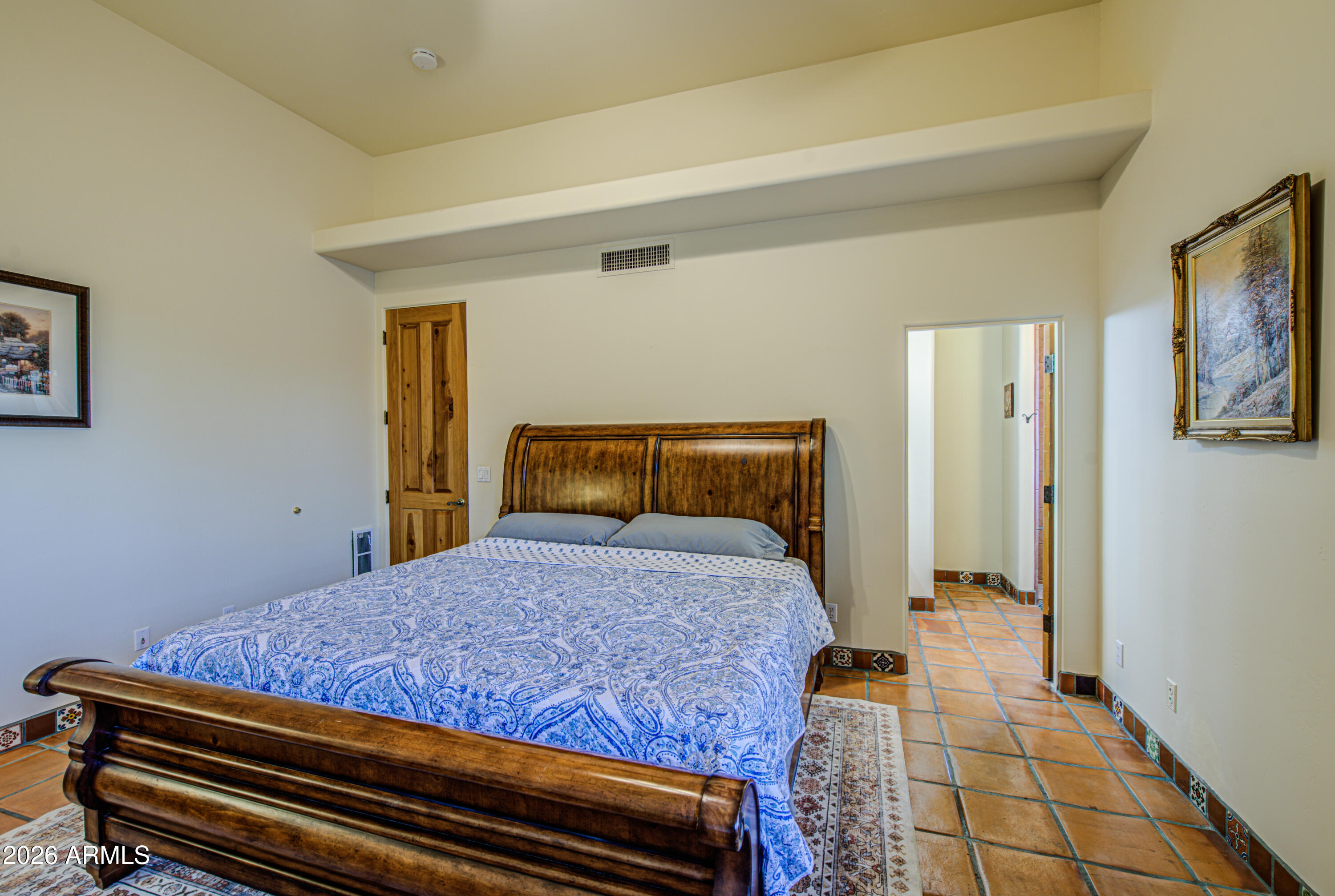 8540 East McDowell Road, Unit 122 Mesa, AZ 85207 - Photo 30 of 75 a bedroom with a bed and wooden floor