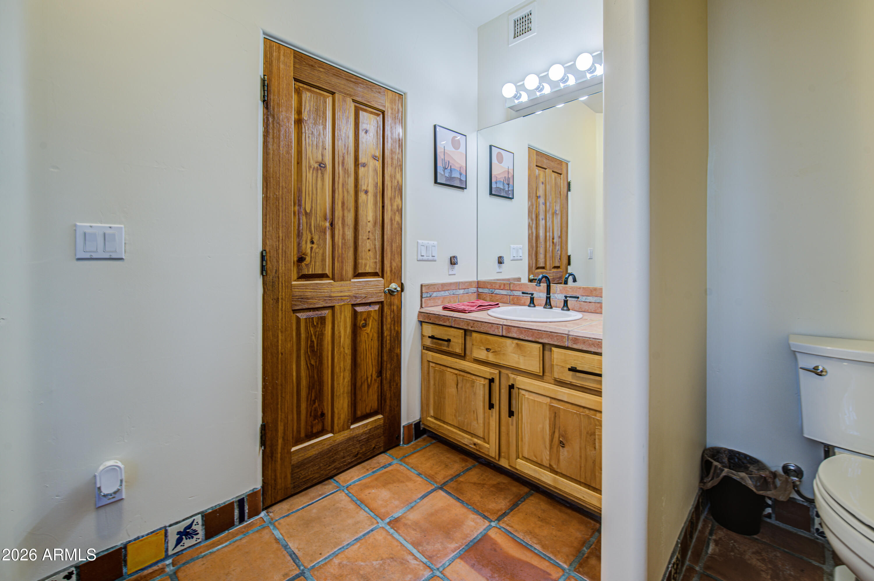 8540 East McDowell Road, Unit 122 Mesa, AZ 85207 - Photo 36 of 75 a bathroom with a sink a mirror and a toilet