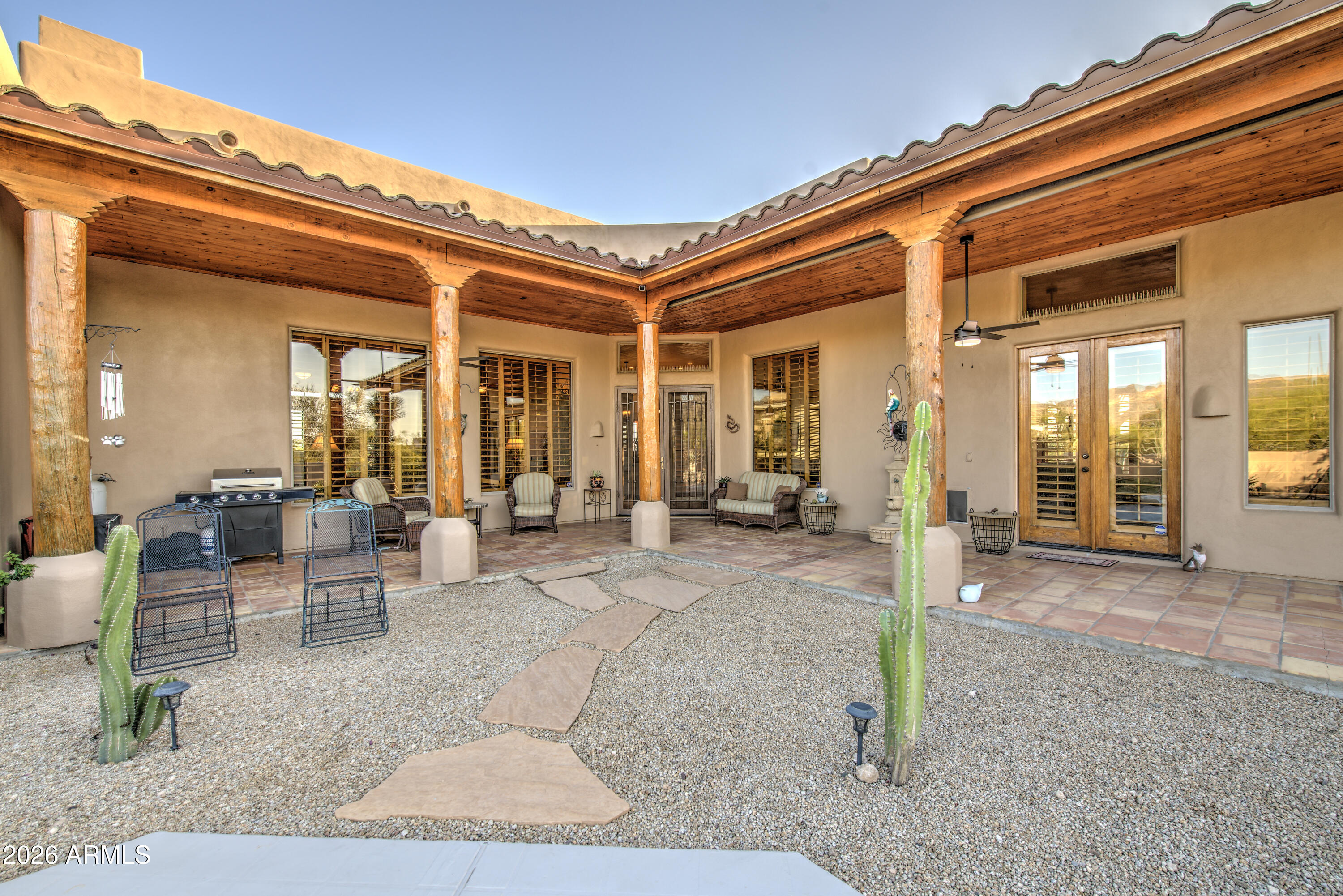 8540 East McDowell Road, Unit 122 Mesa, AZ 85207 - Photo 50 of 75 a view of a building with couches chairs and floor to ceiling window