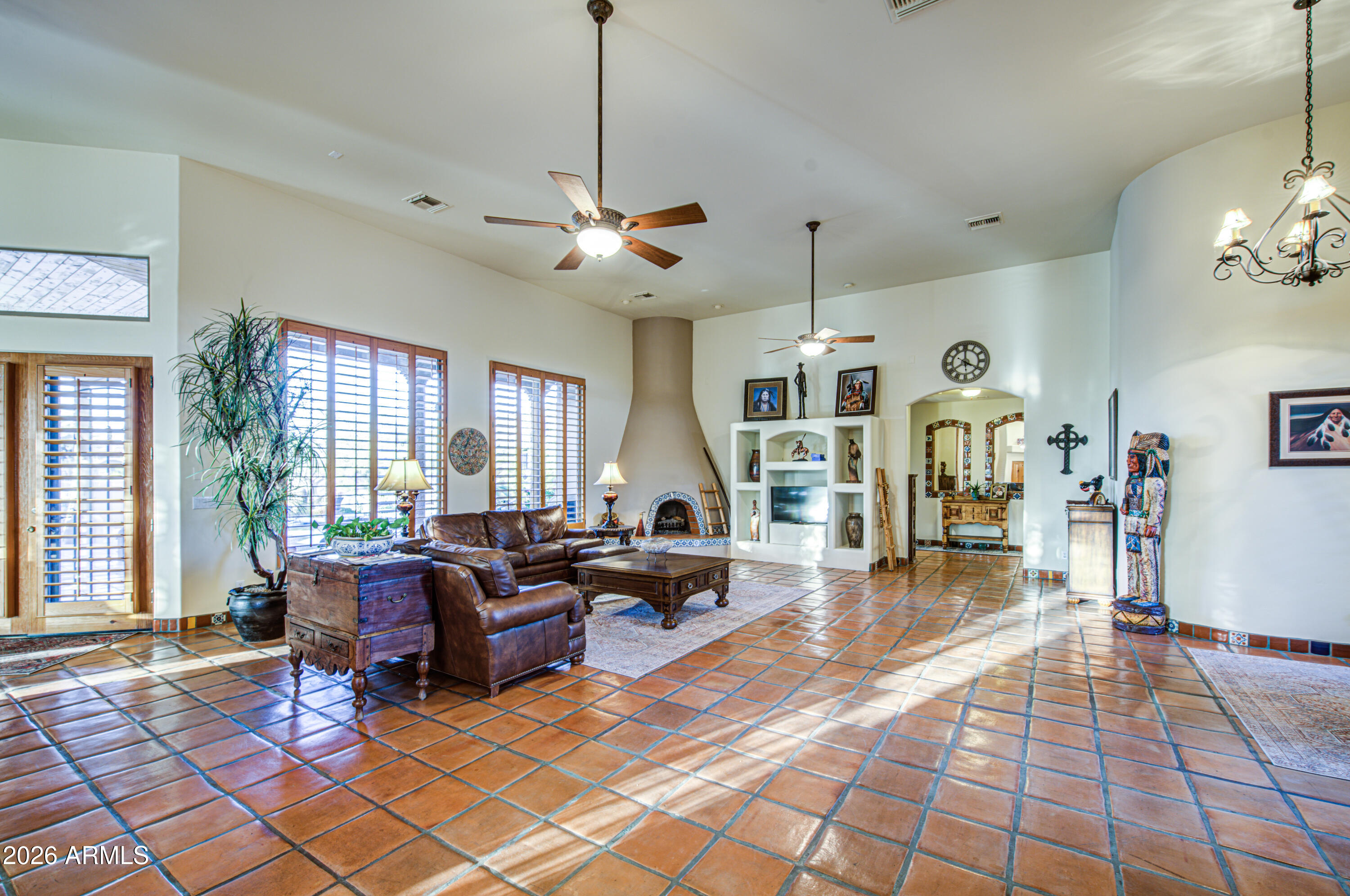 8540 East McDowell Road, Unit 122 Mesa, AZ 85207 - Photo 8 of 75 a living room with lots of furniture and a chandelier