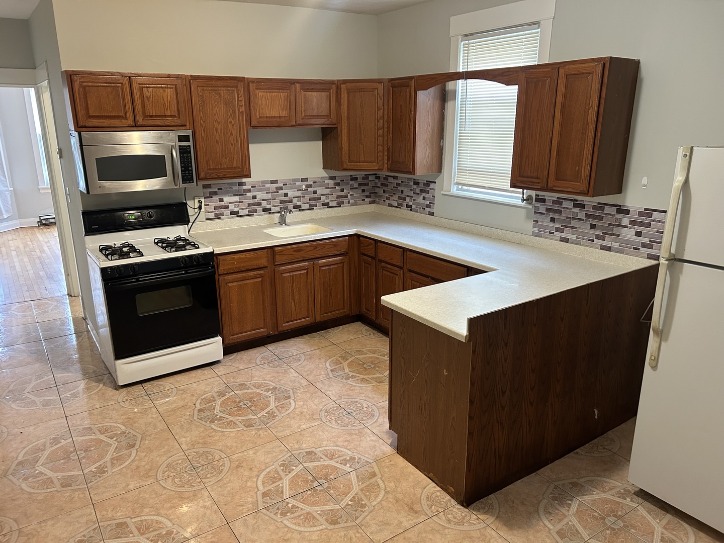 3718 North Spaulding Avenue Chicago, IL 60618 - Photo 12 of 18 a kitchen with stainless steel appliances granite countertop a sink stove and refrigerator