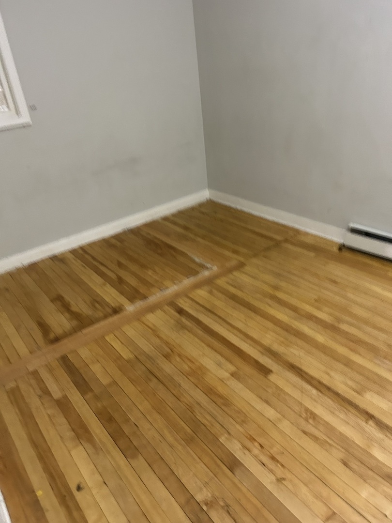 3718 North Spaulding Avenue Chicago, IL 60618 - Photo 16 of 18 a view of empty room with wooden floor