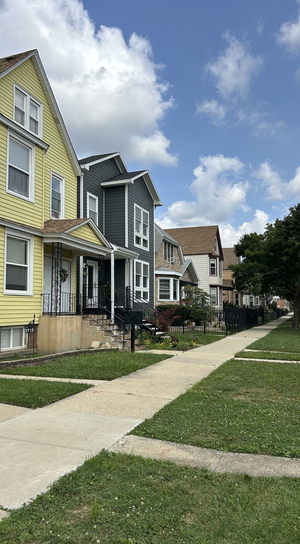 3718 North Spaulding Avenue Chicago, IL 60618 - Photo 4 of 18 a front view of a house with a yard and trees