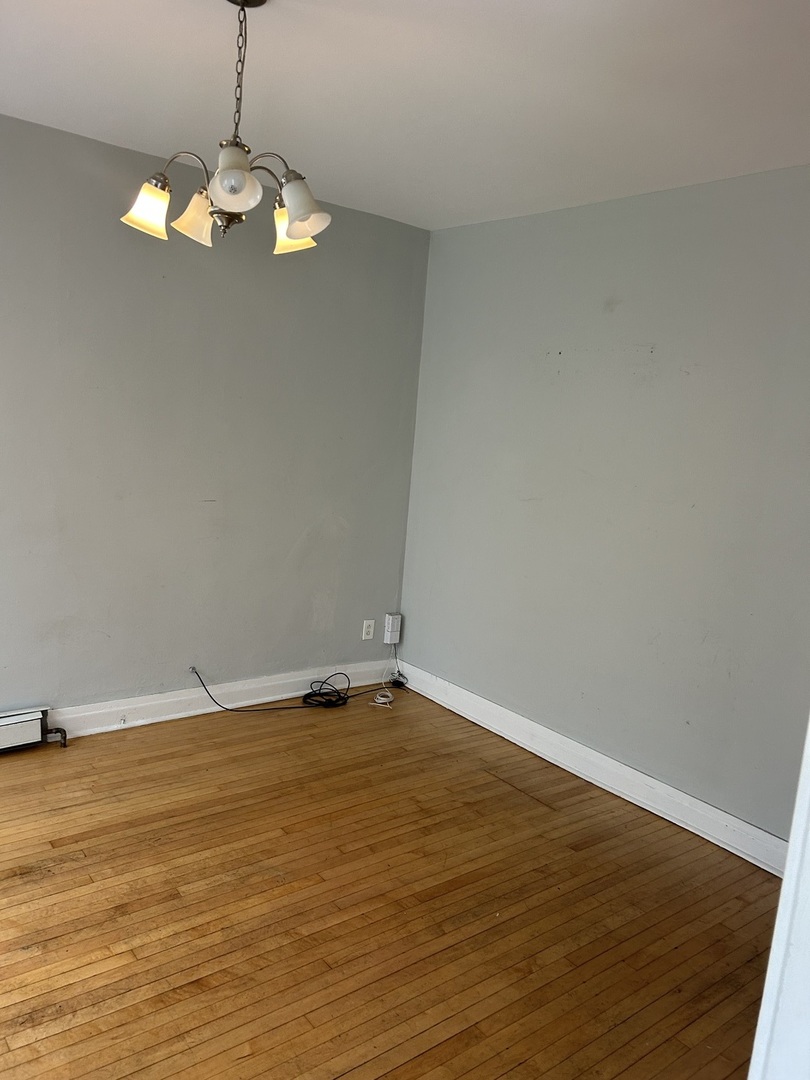 3718 North Spaulding Avenue Chicago, IL 60618 - Photo 5 of 18 a view of an empty room with wooden floor