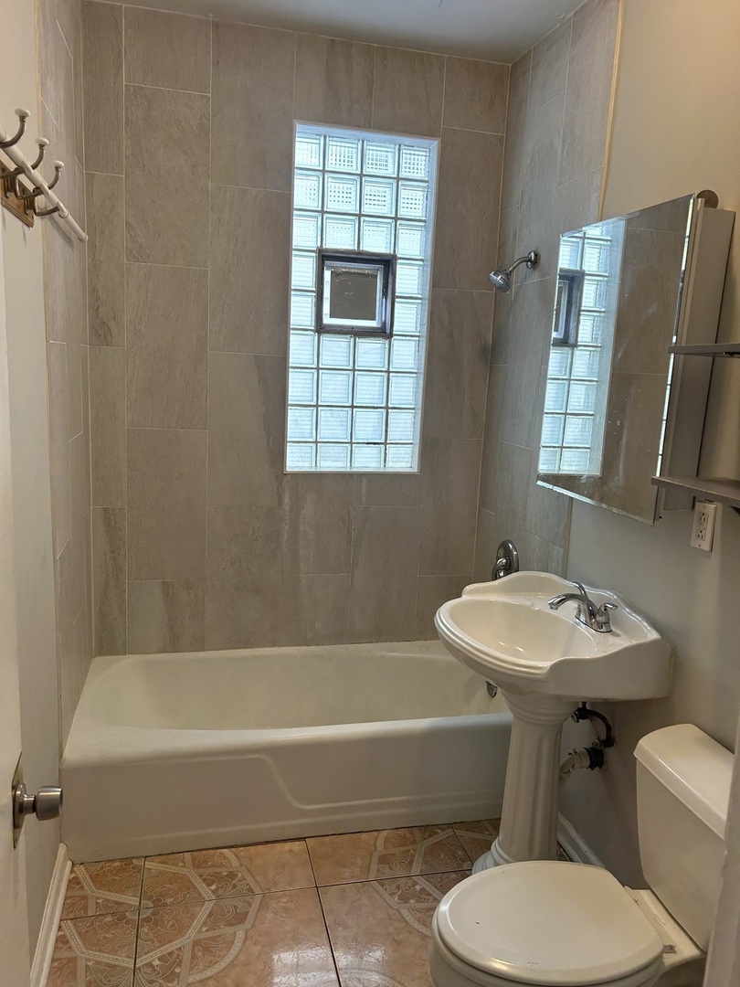 3718 North Spaulding Avenue Chicago, IL 60618 - Photo 9 of 18 a bathroom with a sink toilet and mirror