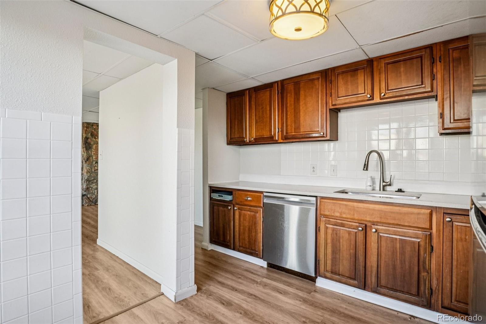 10095 West 35th Avenue Wheat Ridge, CO 80033 - Photo 12 of 50 a kitchen with stainless steel appliances granite countertop a sink and cabinets
