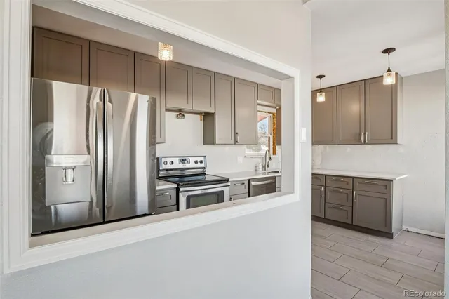 a kitchen with stainless steel appliances a refrigerator stove and sink