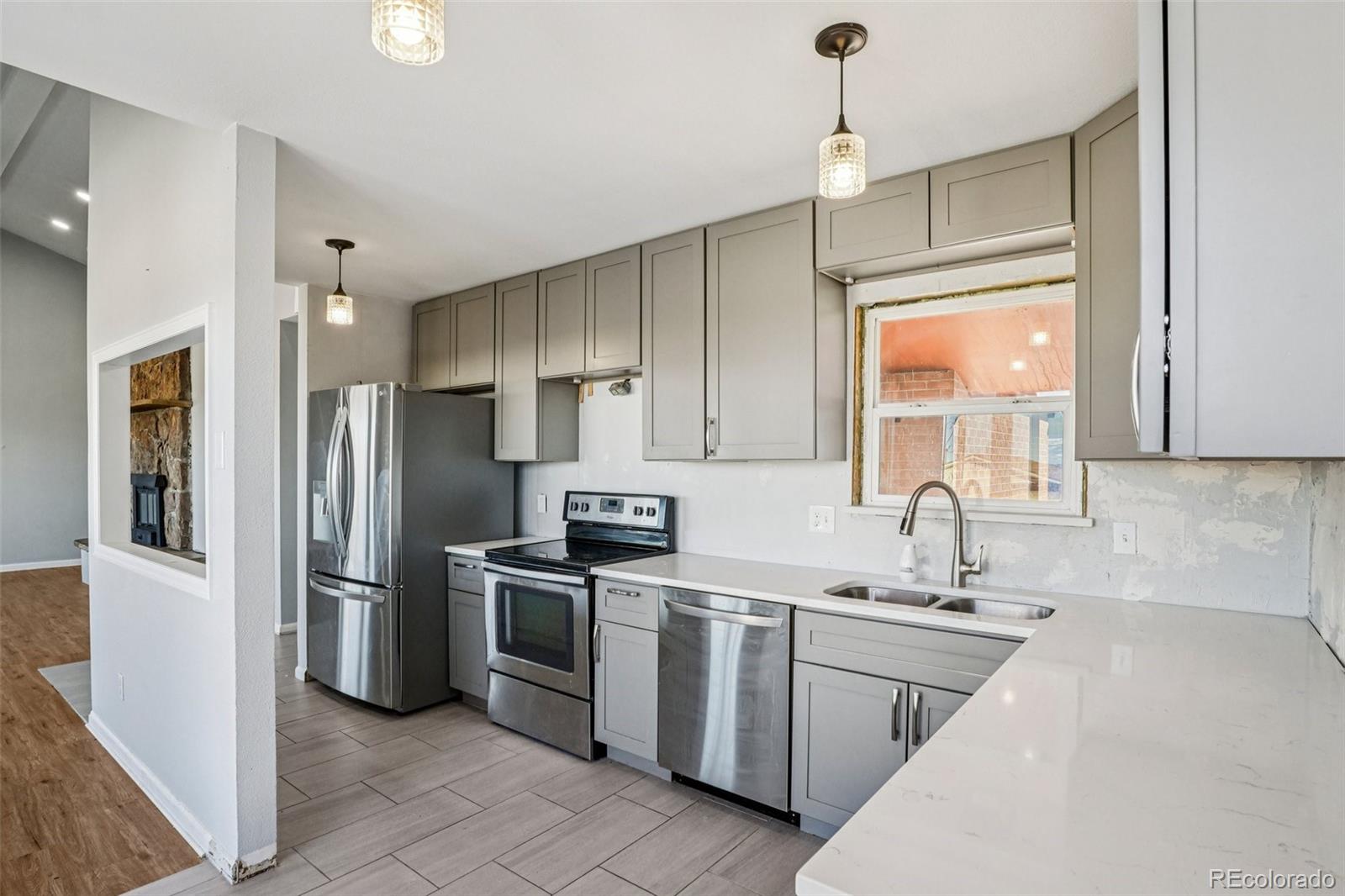 10095 West 35th Avenue Wheat Ridge, CO 80033 - Photo 15 of 50 a kitchen that has a sink stainless steel appliances a counter space and a window