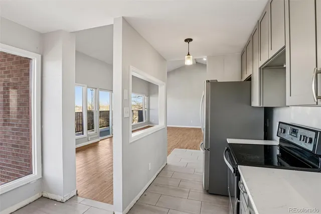 a kitchen with granite countertop a refrigerator and a sink