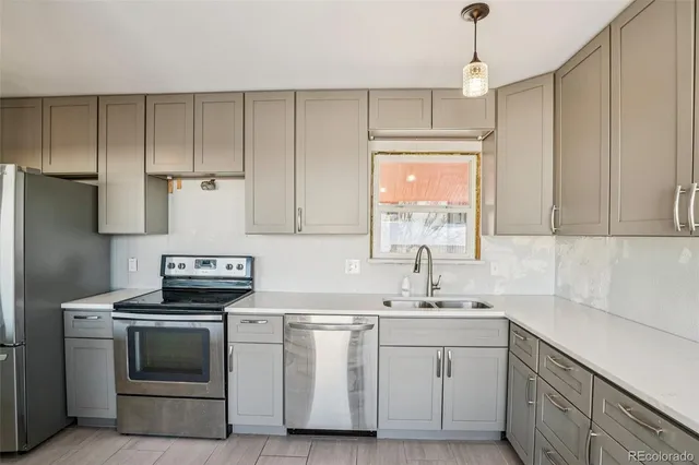 a kitchen with white cabinets and white appliances