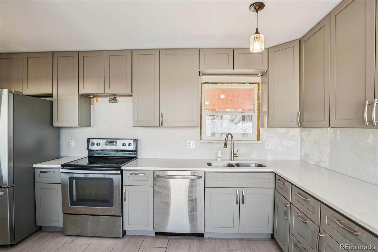10095 West 35th Avenue Wheat Ridge, CO 80033 - Photo 17 of 50 a kitchen with white cabinets and white appliances