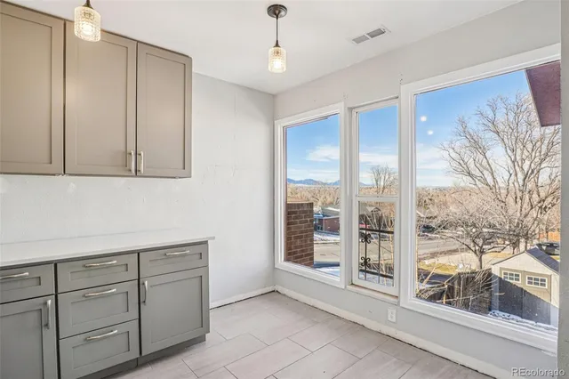 a view of a room with cabinet mirror and windows