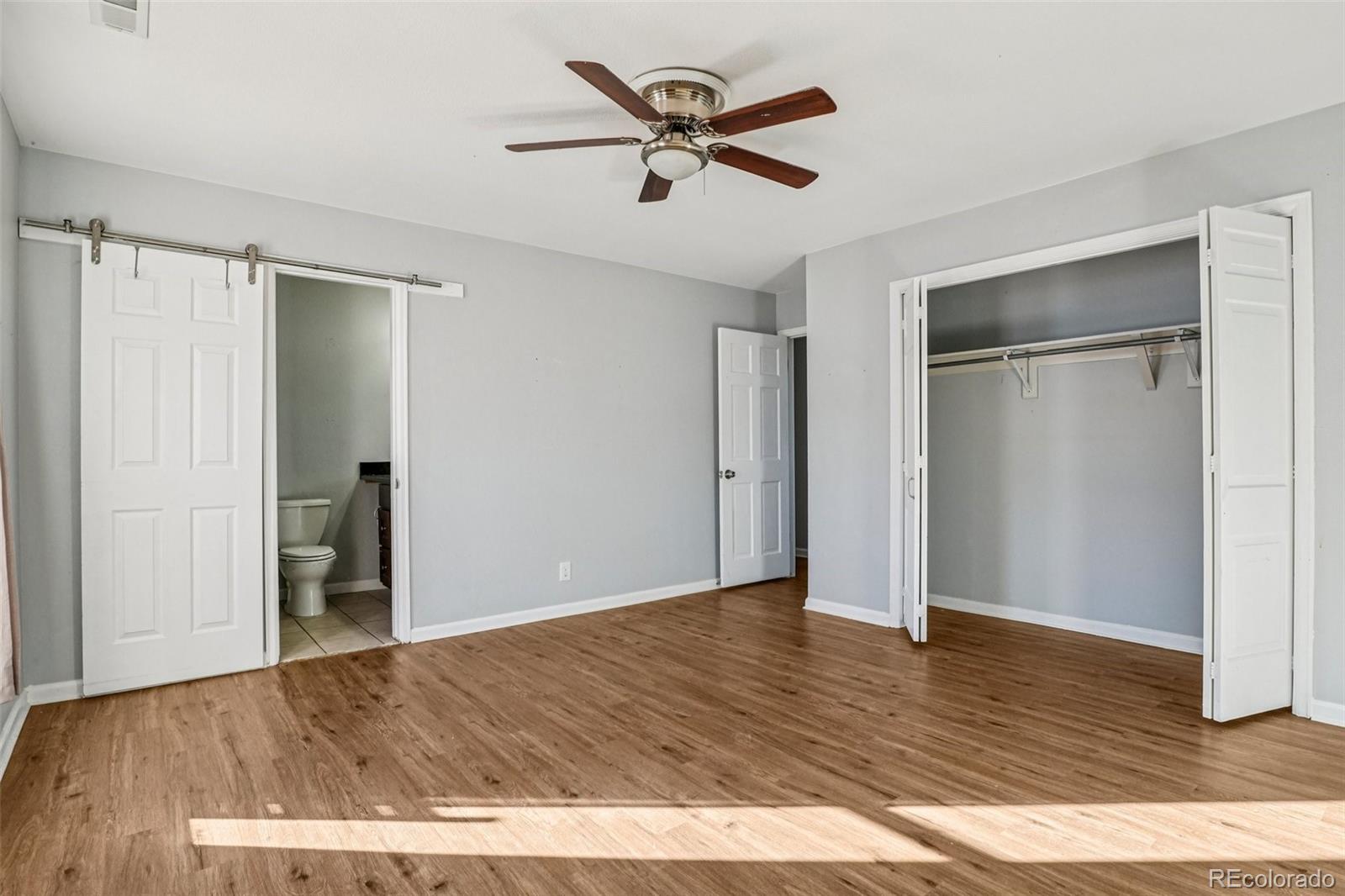 10095 West 35th Avenue Wheat Ridge, CO 80033 - Photo 20 of 50 an empty room with wooden floor and a ceiling fan