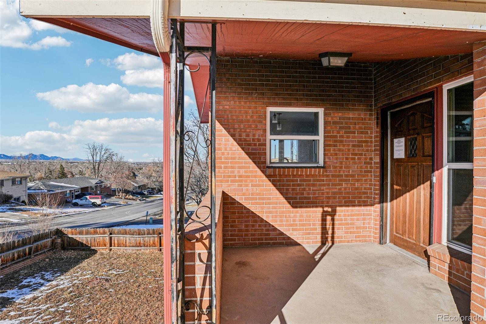 10095 West 35th Avenue Wheat Ridge, CO 80033 - Photo 2 of 50 a view of a balcony with wooden floor and iron stairs