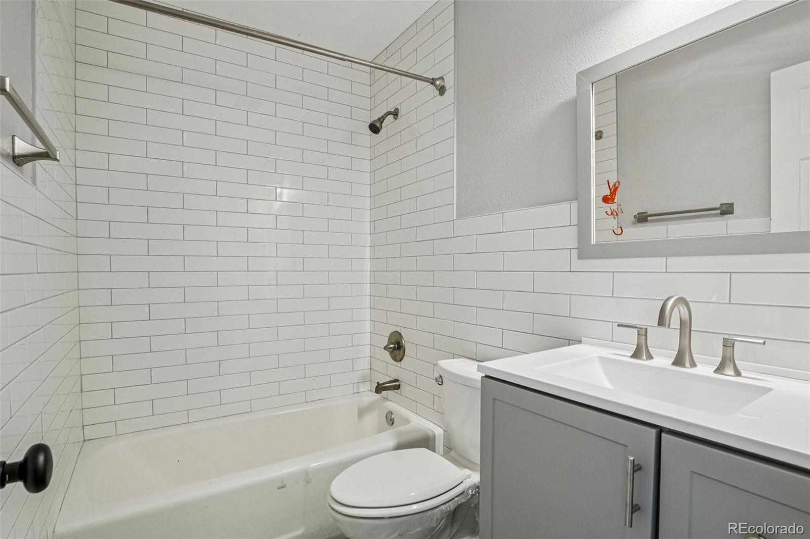 10095 West 35th Avenue Wheat Ridge, CO 80033 - Photo 27 of 50 a bathroom with a sink a toilet and shower