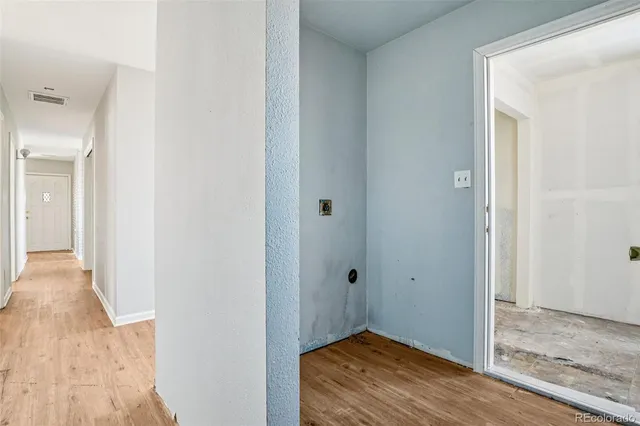 a view of a hallway with wooden floor
