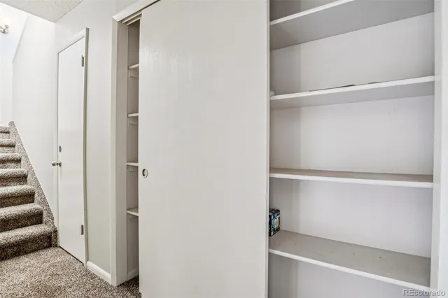a view of a room with wooden floor and window