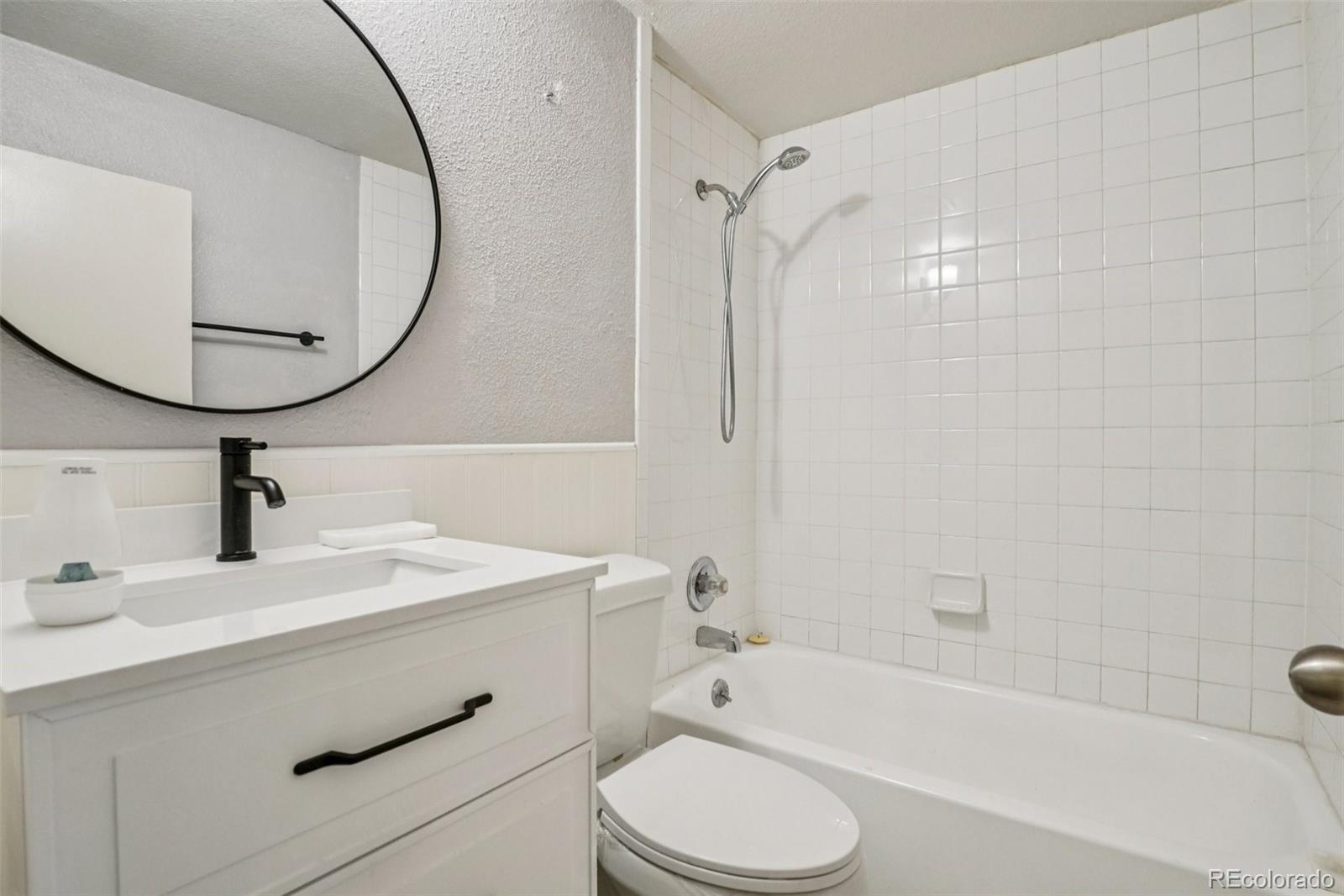 10095 West 35th Avenue Wheat Ridge, CO 80033 - Photo 40 of 50 a bathroom with a sink toilet and shower