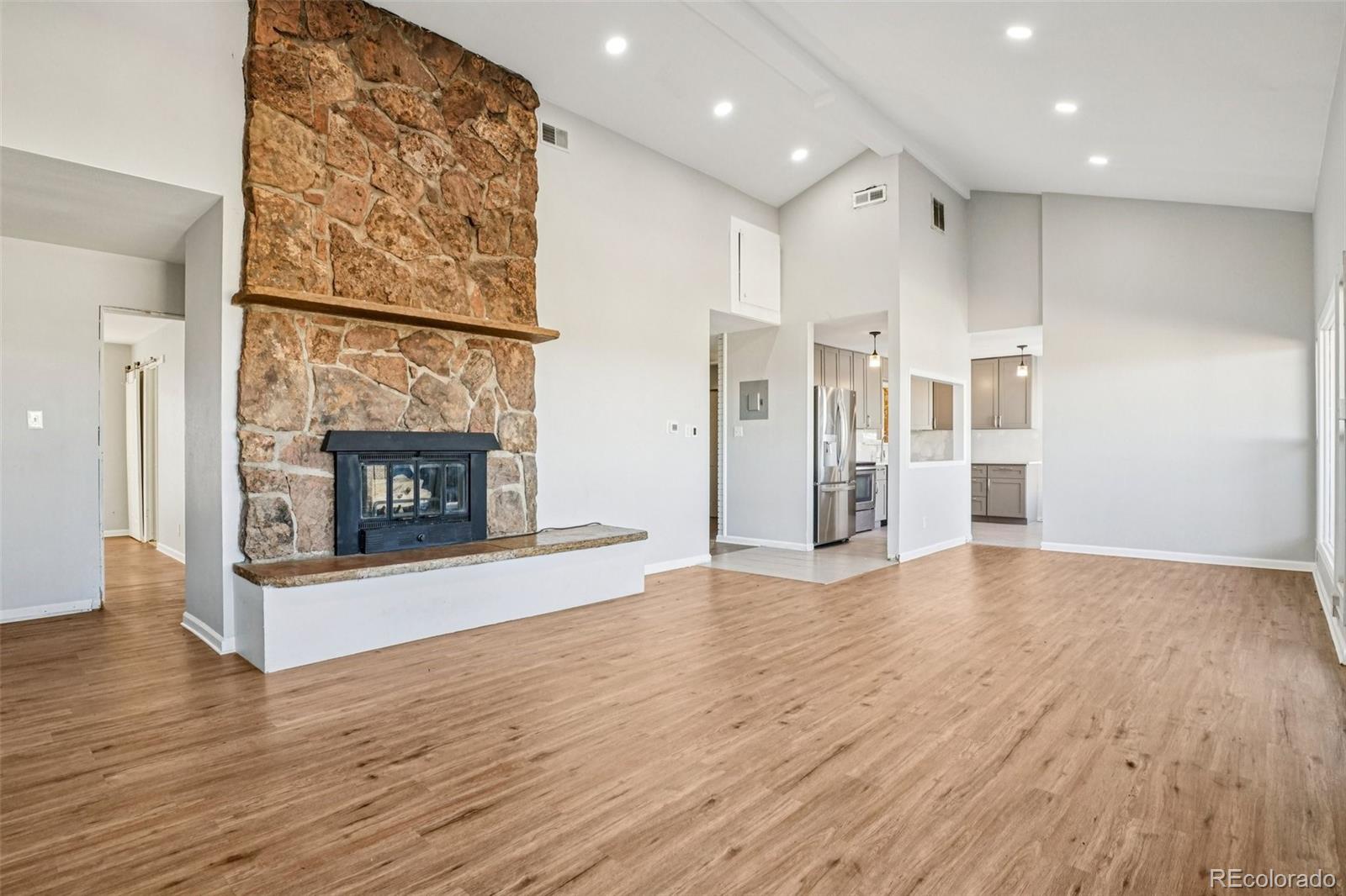10095 West 35th Avenue Wheat Ridge, CO 80033 - Photo 6 of 50 a view of a livingroom with wooden floor and a fireplace