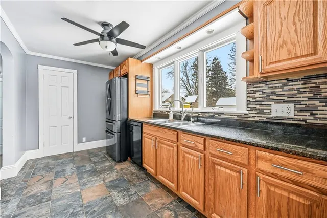 a bathroom with a granite countertop sink and a window