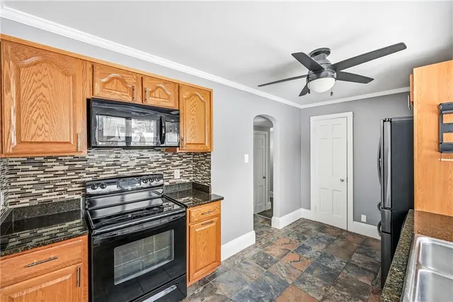 a kitchen with stainless steel appliances granite countertop a stove a sink and a refrigerator