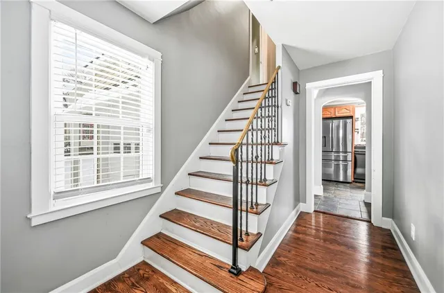 a view of entryway with wooden floor and stairs
