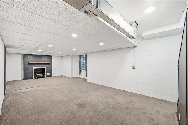 an empty room with fireplace and windows