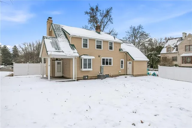 a front view of a house with a dirt yard