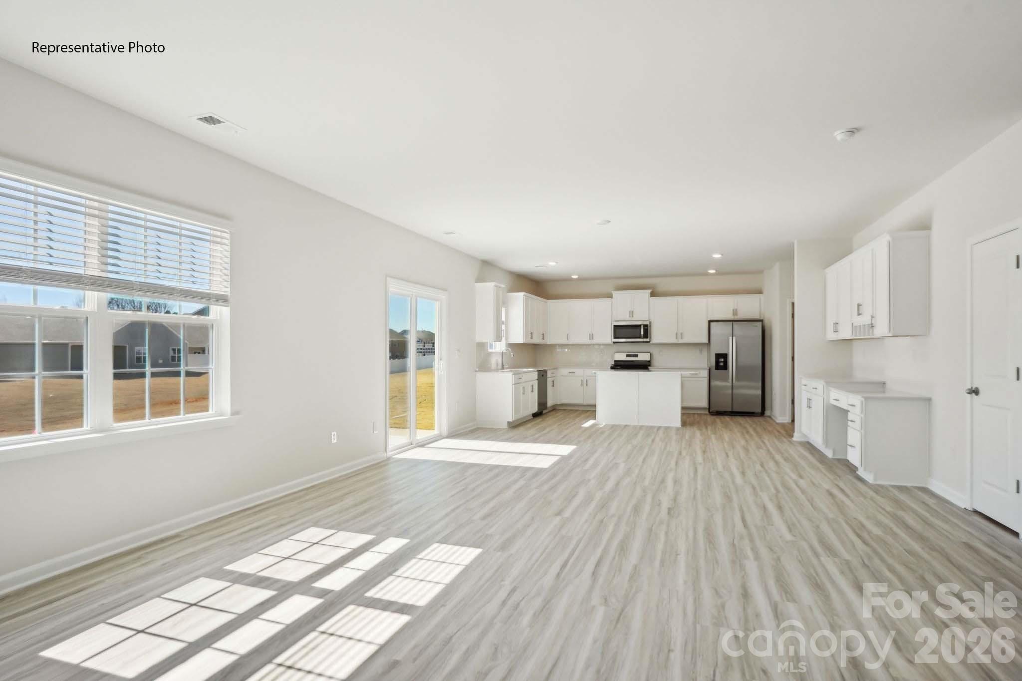 2015 Moorside Court Lancaster, SC 29720 - Photo 14 of 46 a view of a kitchen with kitchen island stainless steel appliances wooden floor and windows