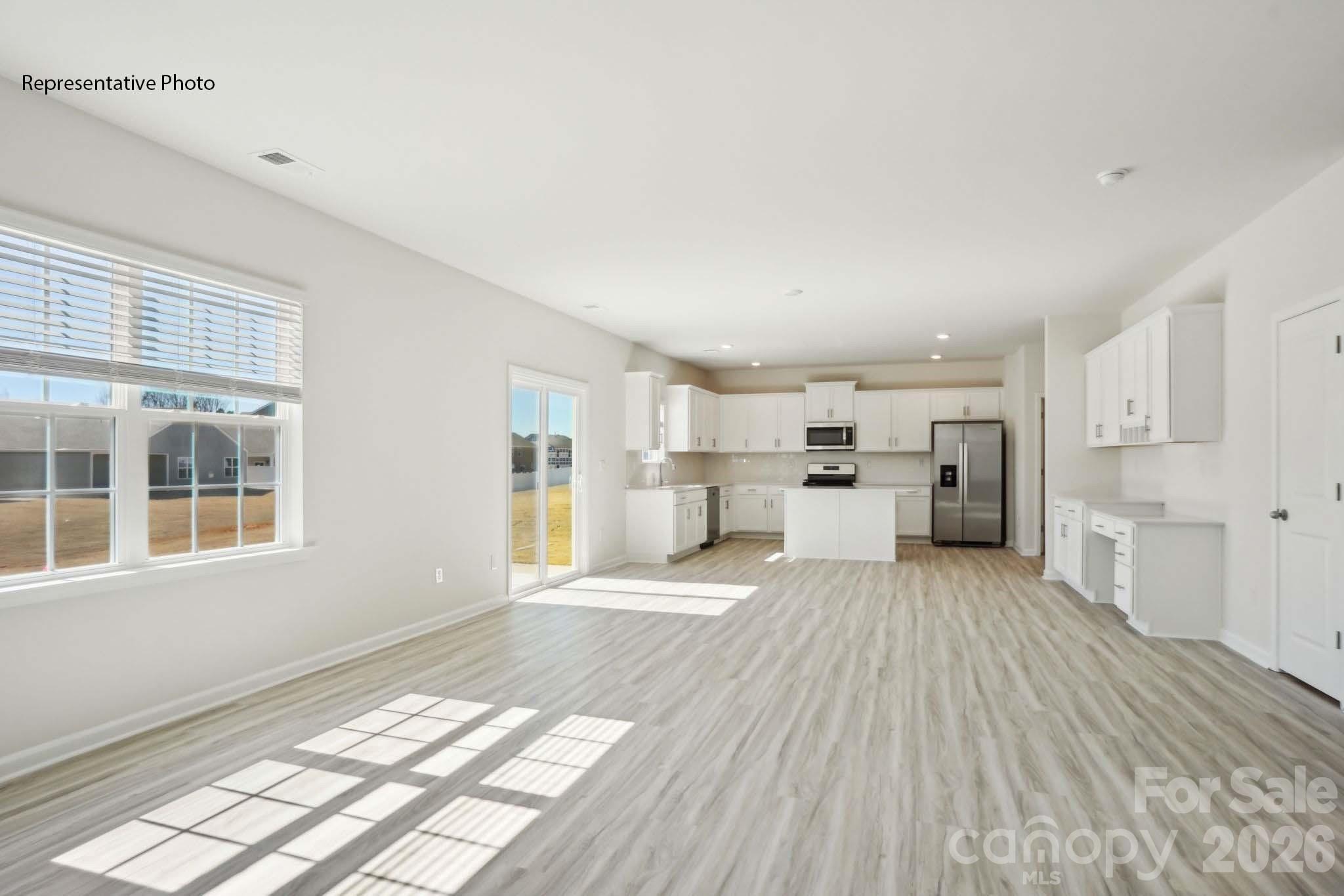 2015 Moorside Court Lancaster, SC 29720 - Photo 15 of 46 a view of a kitchen with kitchen island stainless steel appliances wooden floor and windows