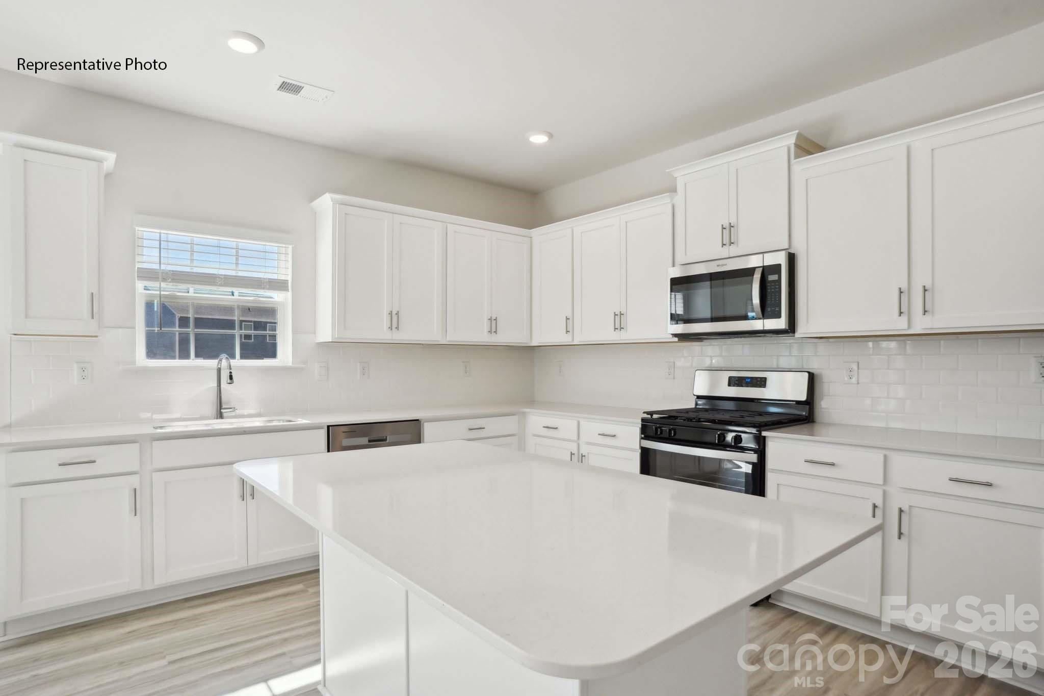 2015 Moorside Court Lancaster, SC 29720 - Photo 21 of 46 a kitchen with stainless steel appliances granite countertop a sink a stove and cabinets