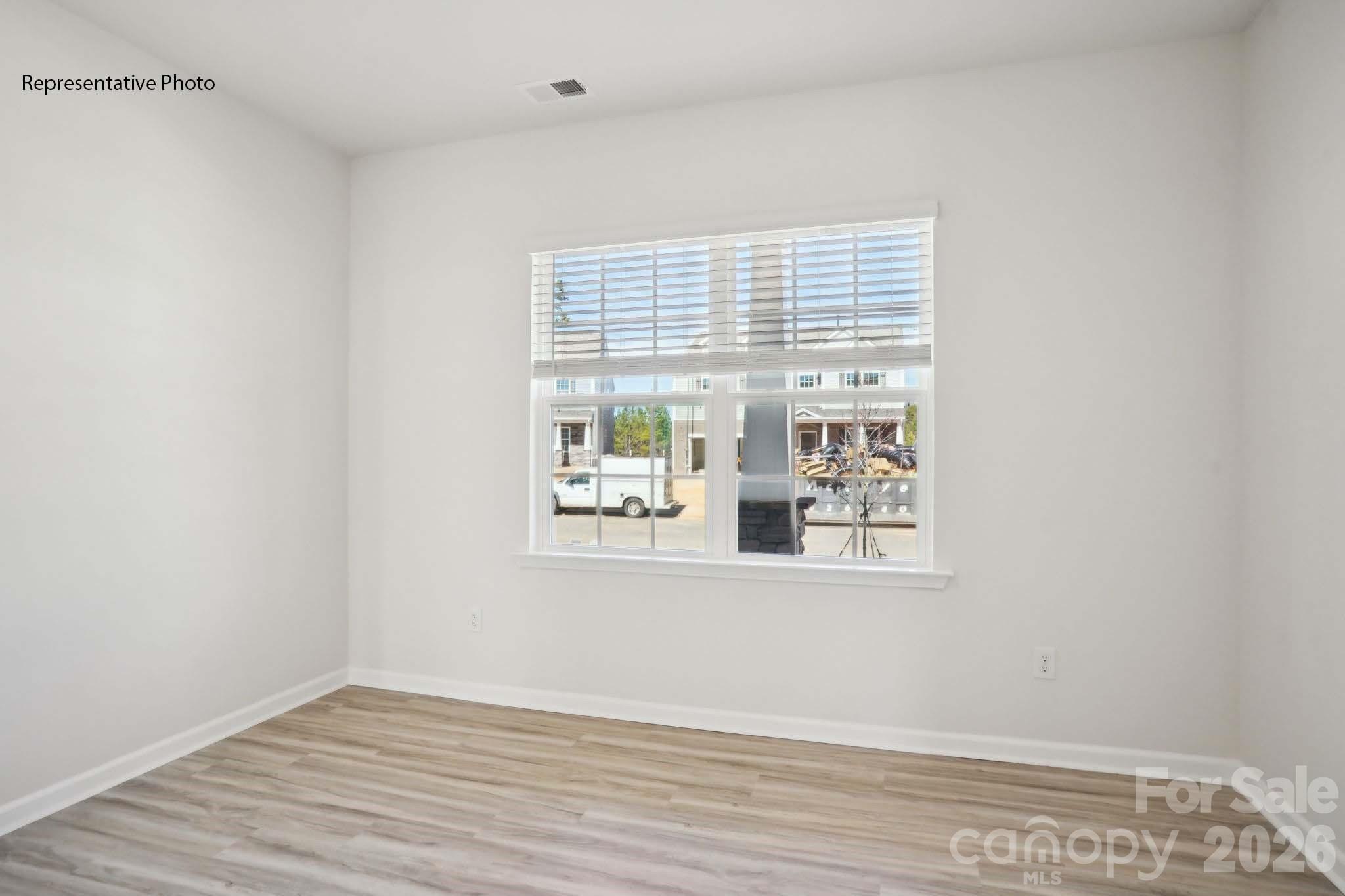 2015 Moorside Court Lancaster, SC 29720 - Photo 27 of 46 a view of an empty room with wooden floor and a window