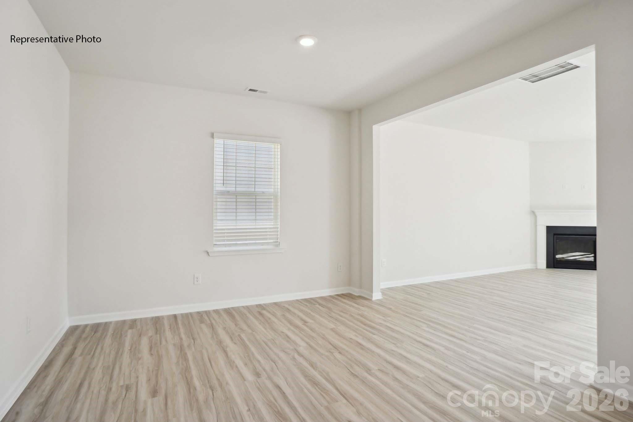 2015 Moorside Court Lancaster, SC 29720 - Photo 7 of 46 a view of an empty room with wooden floor and a window