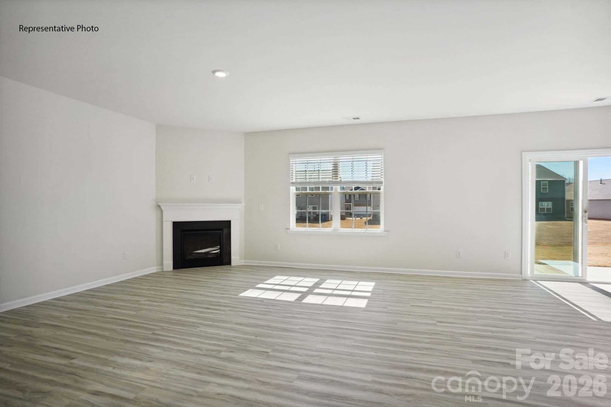 2015 Moorside Court Lancaster, SC 29720 - Photo 8 of 46 a view of empty room with wooden floor and fireplace