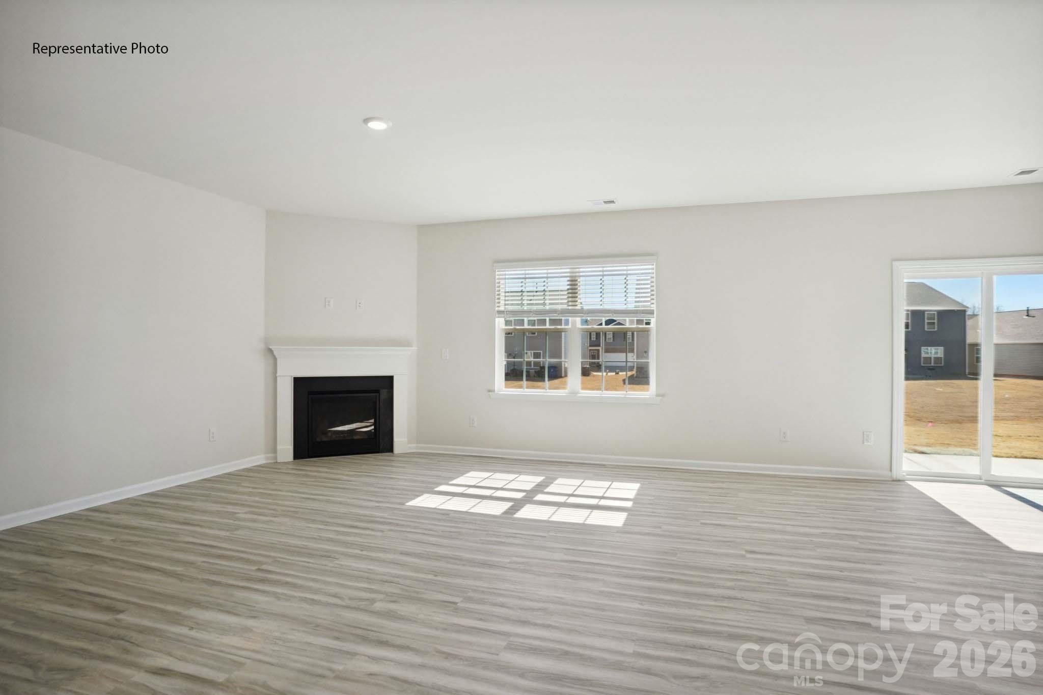 2015 Moorside Court Lancaster, SC 29720 - Photo 10 of 46 wooden floor in an empty room with a fireplace