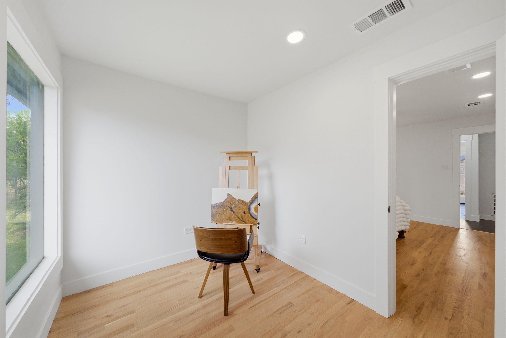 3128 Prospect Street Houston, TX 77004 - Photo 19 of 36 a view of room with a chandelier and wooden floor
