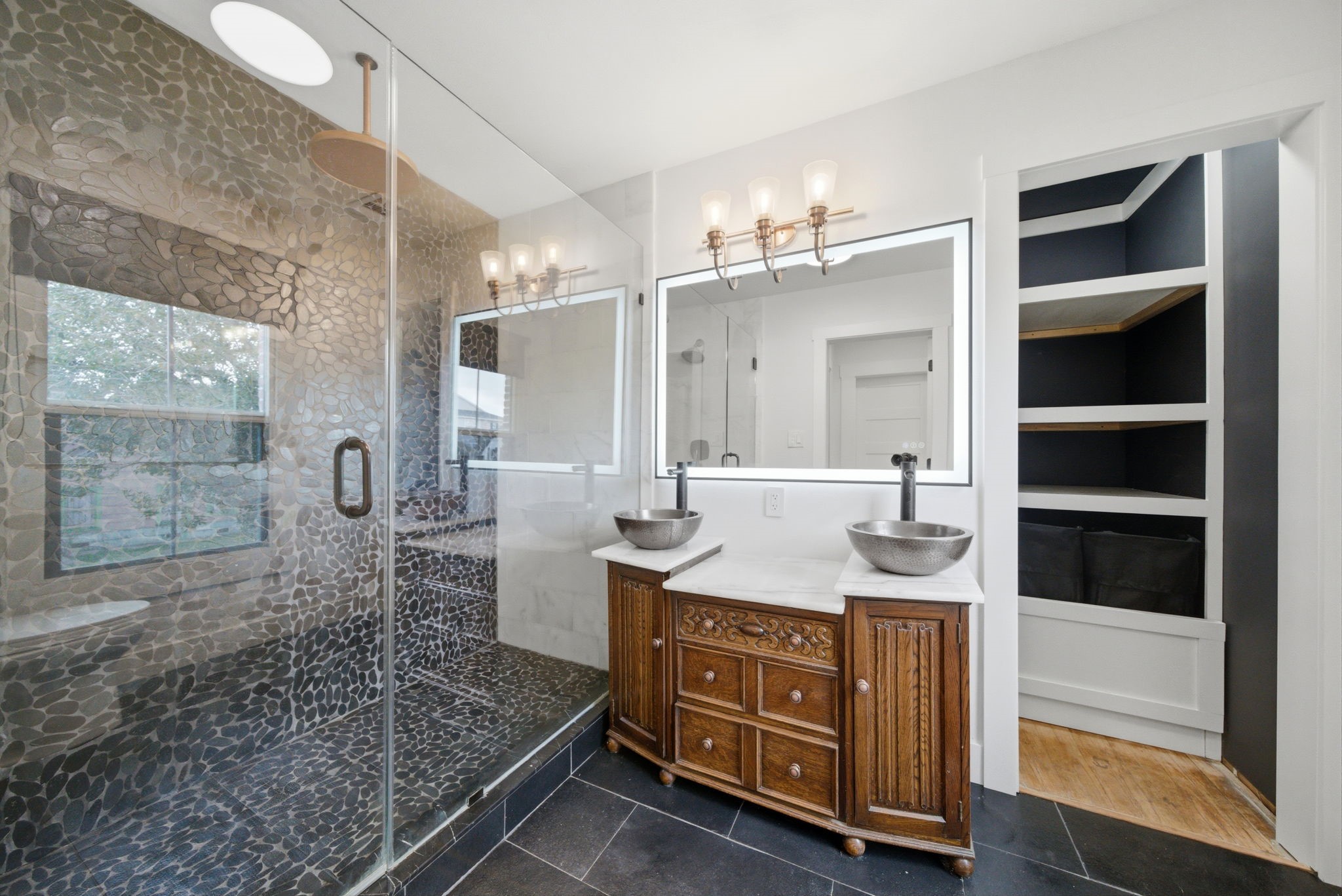3128 Prospect Street Houston, TX 77004 - Photo 26 of 36 a bathroom with a granite countertop sink a mirror and shower
