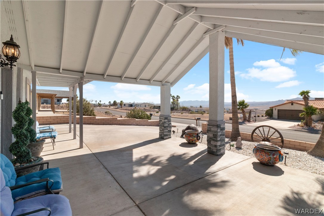 784 Pegasus Ranch Road Bullhead City, AZ 86429 - Photo 66 of 100 Covered patio with exposed beam ceiling and stone-accented support columns